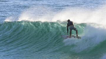Deano surfing at Flynns Beach. Picture by Andrew Lister