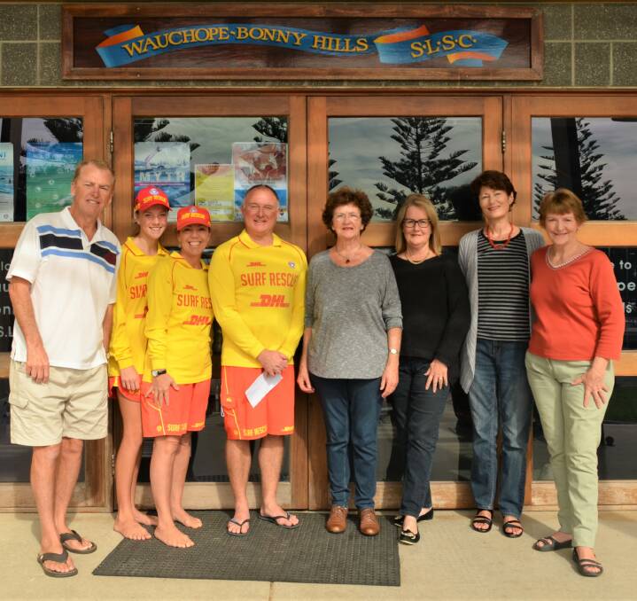 Donation: Jeoff Ryan, Bec and Gayl Ellis, surf club president Peter Smith, Bonny Hills artist Kim Madden, with Jill Woodlands, and artists, Lyn Thomas and Jan Wilson.