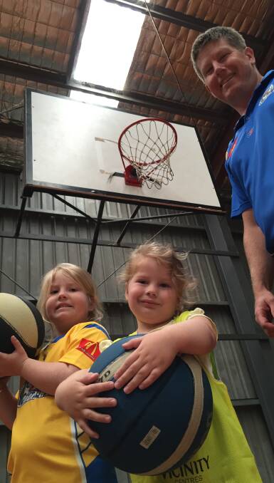 Junior hoops: Jason Berry and his daughters Peyton and Kalani preparing for the start of Aussie Hoops.
