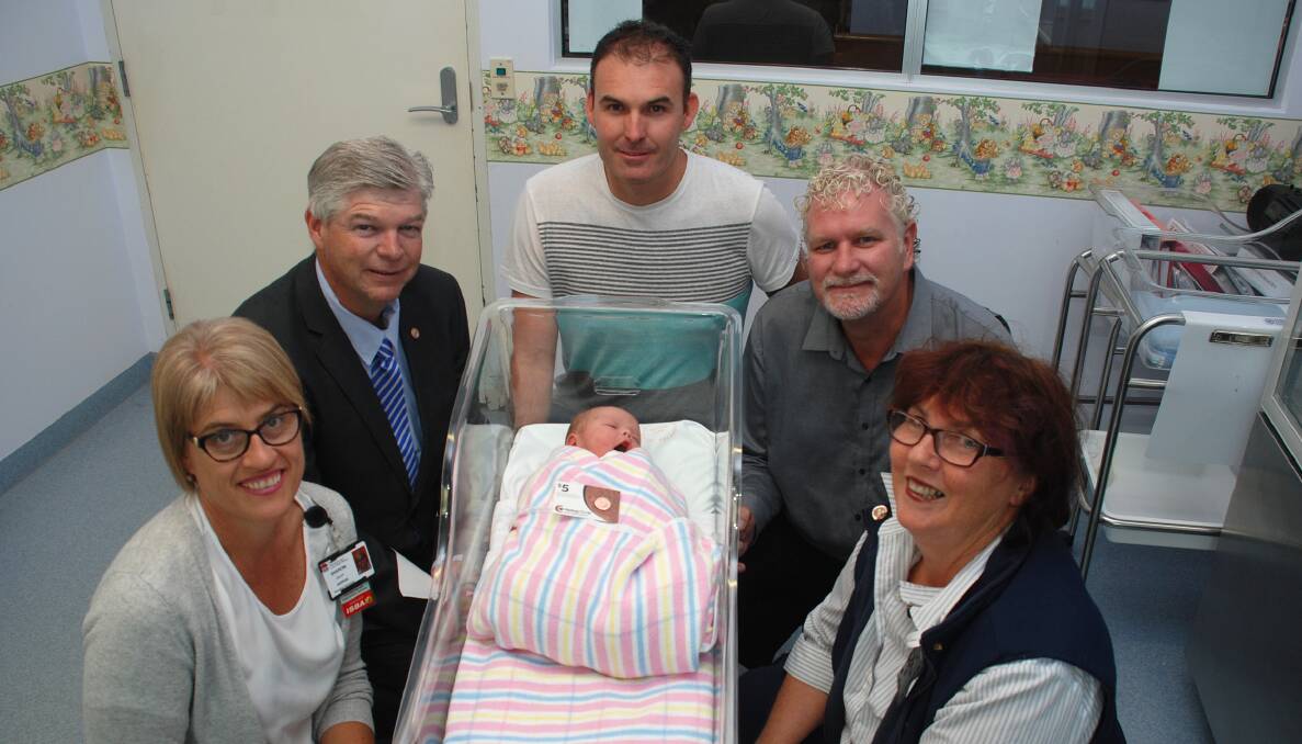 The youngest recipient of a 100-year Hastings Co-op commemorative pin, three-hour-old Harvey Pettitt and dad Christian, (centre) with Acting Deputy Director of Nursing Sharon Gouck, Hastings Co-op CEO Alan Gordon, Co-op Branding and Events Manager Tim Walker and Maternity Unit Manager Sandra Eadie.