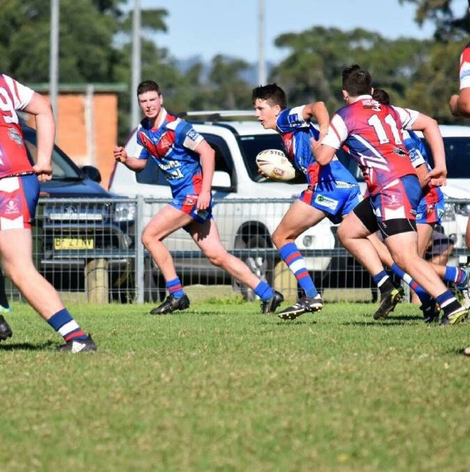 DETERMINATION: Under 18s player Ryan Maggs on the attack for the Wauchope Blues.