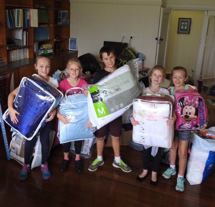 HELPING FLOOD VICTIMS: Bella Cook, Sophie Marchment, Brendan Walsh, Olivia Holloway, Emily Cook.