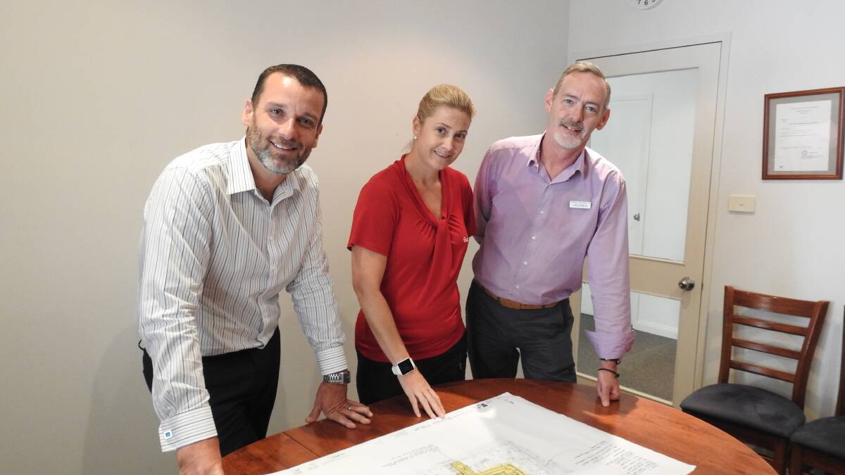 Bundaleer CEO Gareth Norman, Operations Manager Helena Lawrie and Director of Nursing Stephen Reilly look at plans for the new home.