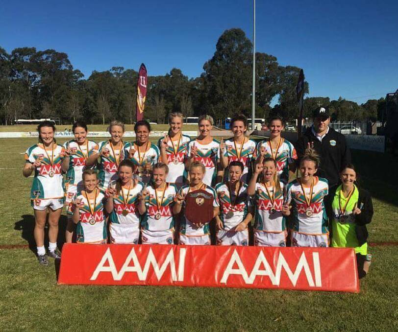 Celebrating their success: the East Coast Dolphins with their ladies league tag country championships winner's shield after they beat the Central Coast Centurions at Cessnock earlier this month.