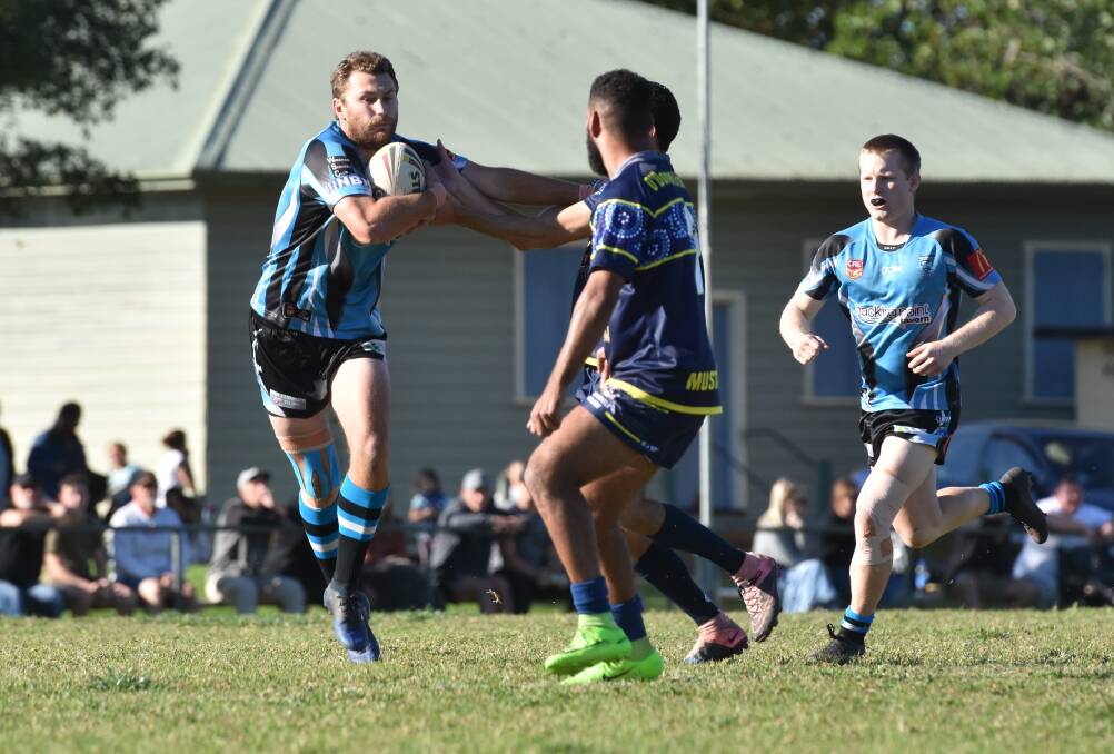 Good fend: Corey Murphy tries to break away from the Macleay Valley defence during Sunday's 40-32 loss in Kempsey. Photo: Paul Jobber