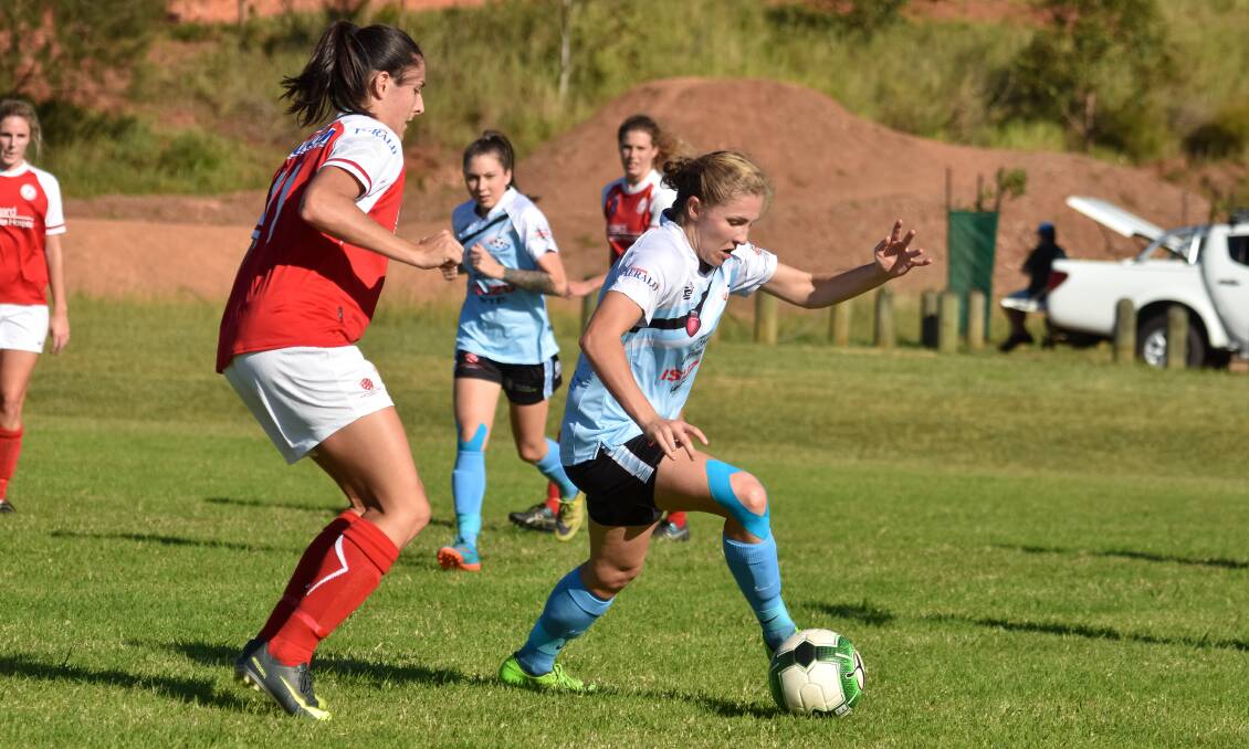 On the move: Mid North Coast's Sophie Jones brings the ball out from defence. Photo: Ivan Sajko