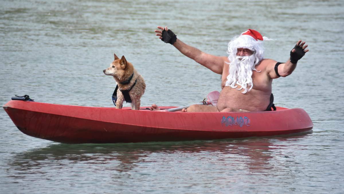 Santa, aka Ron Hunter, and Spike in the kayak on Lake Cathie