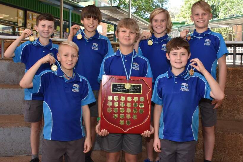 Champions: 2016 Hastings Public School NSW Tournament of Minds Champions for Maths and Engineering (back) Sachin Sen Gupta, Sam Kobelke, Finn Hoy, Axel Lindeman, (front) Oliver Barry, Kael Harris and Nicholas Saad display their medals and trophy.