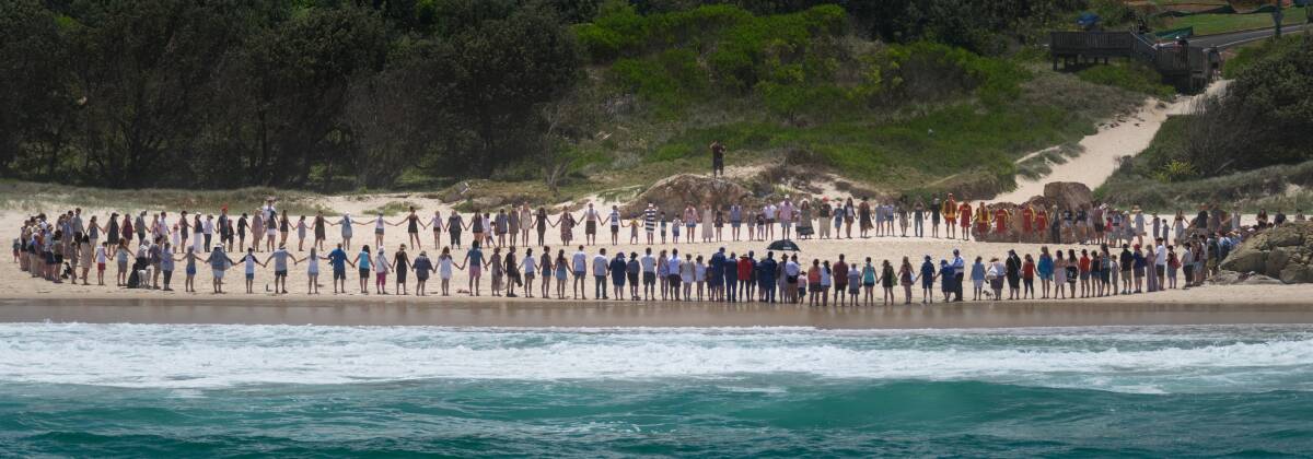 The community gathered on Lighthouse Beach to show support to the family. Photo: Alex McNaught.