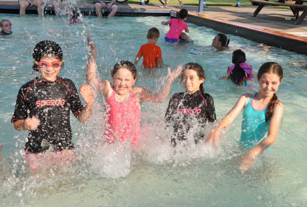 Cool relief: June Mea, Alana Steele, Jubi Mea and Makayla Steele were among the hundreds of school children who swarmed to Wauchope Olympic Pool.
