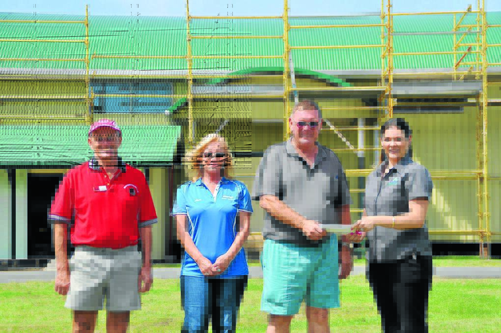 Signed, sealed and delivered: Wauchope Show Society president Bob Kennett, second from right, hands over payment for the new Trades Hall roof to Melissa Cooper, of Scott Cooper Metal Roofing and Earthmoving, watched by Show Society vice-president Neil Coombes and secretary Anne Watkins.