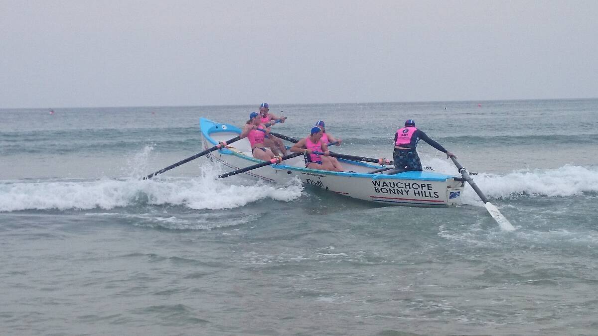 Surfboat hero helping: The Wauchope-Bonny Hills reserve grade crew rowing up and over breakers at Scotts Head.