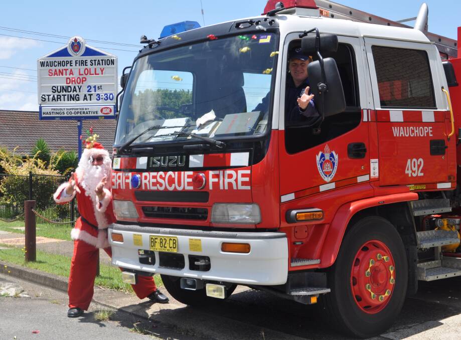 Delightful drop: Santa was on hand to help Wauchope Fire and Rescue Captain Rob Pursehouse practice the art of lolly throwing ahead of Sunday's annual lolly drop through the streets of Wauchope