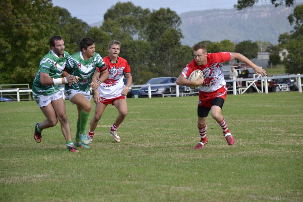 Catch me if you can: Long Flat s Jason Smith trying to avoid the Beechwood defence during Saturday's Hastings League clash.