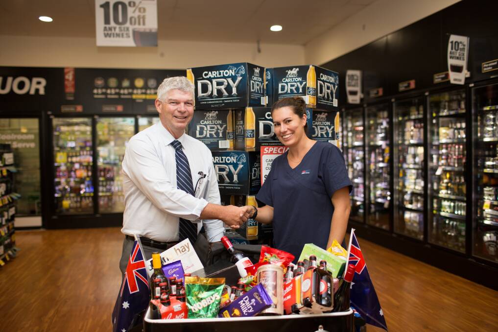 Hastings Co-op chief executive officer Allan Gordon congratulates Wauchope nurse Erin Lay on winning the Australia Day Liquor Hamper valued at $450. Proceeds from the hamper raffle helped raise funds for the Westpac Rescue Helicopter Service through the Leap for Life project.&#13;* The Leaders Leap for Life abseiling event, which was due to take place last Friday night, was rained-out . The Westpac Rescue Helicopter Service fundraiser will now take place on Friday, February 20. People can continue to make donations at leadersleapforlife.gofundraise.com.au
