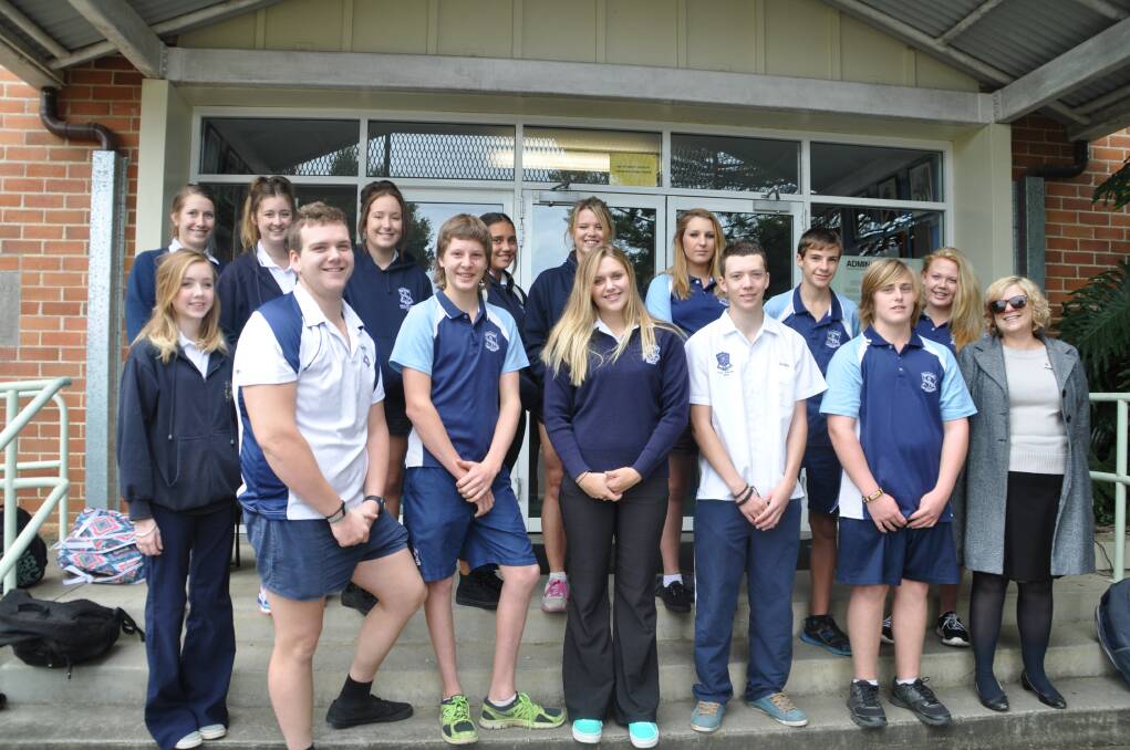 Inspiration: Some of the students who will be attending the Luminosity Youth Summit, backed by their community, lined up on the front steps of the school with deputy principal Nicole Gough for the Gazette's camera on Tuesday.
