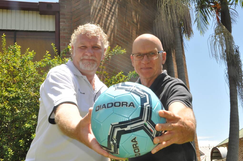 Joining forces: Hastings Co-op marketing and communications manager Tim Walker and Football Mid North Coast general manager Peter Daniels are looking forward to the local men's and women's football competitions kicking off for 2016.