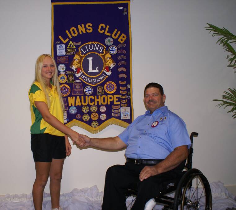 Helping hand: Georgia Williams with Stephen Perkins, Lions Sports Foundation Chairman has received some much appreciated financial assistance from the Wauchope Lions Club.