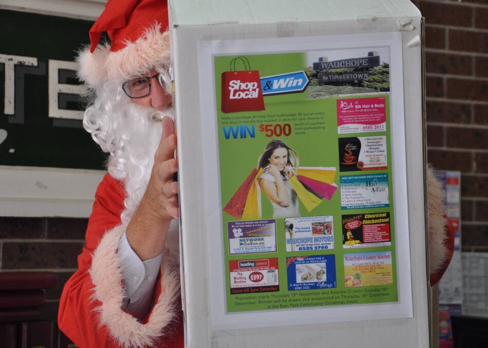 Guess who: A cheeky Santa made a cameo at the Wauchope Gazette office this week to take a look at entry numbers for the Shop Local and Win competition that will be drawn tonight at the Bain Park community Christmas event.