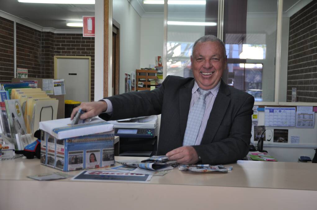 Vote now: Wauchope Chamber of Commerce President Rob Hamilton peruses the dozens of votes already received for this year's Excellence in Service Awards at the Gazette office this week.