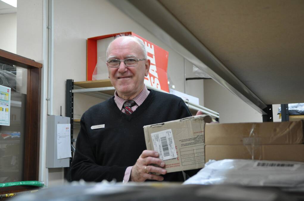 Satisfying career comes to an end: Familiar face, Don Berry at work in the Wauchope Post Office.
