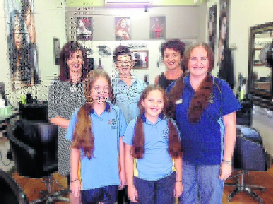 Before: From left at back, hairdressers Joy Ward, Ami Andrews and Jenni Sheather with Makayla, Alannah and Kelly Steele before their hair was cut.