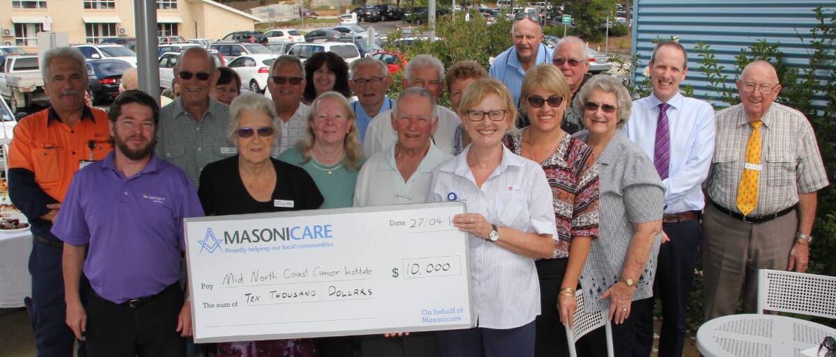 Well done: Mid North Coast Cancer Institute Nursing Unit Manager Jennifer Baroutis holds the cheque made possible by Freemasons and their partners representing Lodges from throughout the Hastings and Macleay and the organisation's official charity in NSW, Masonicare.