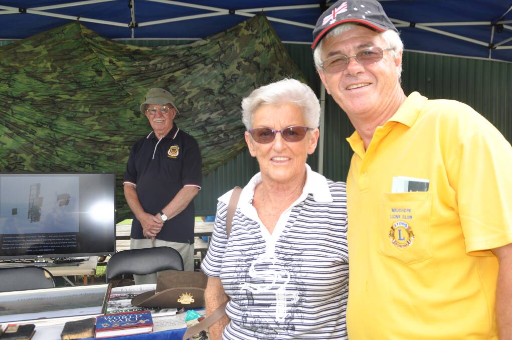 Memories: Wearing his Legacy hat for the day, Greg Cavanagh chats with Legacy widow Ann Bright, in front of the Anzac memorabilia stand manned by Dave Harding.