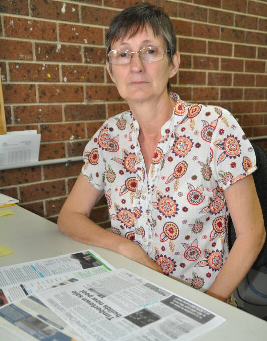 Grave concerns: Heated indoor pool committee president Di Gilbert goes over clippings on the long-running campaign ahead of the council meeting this week
