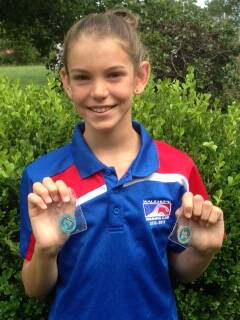 Solo effort: Wauchope Swimming club's Phoebe Bentley with the two medals she won at the NSW Country Regional Swim Meet.