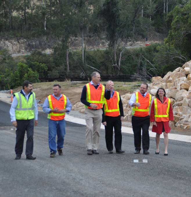 Worth waiting for: Inspecting the new section of Beechwood Road on Monday morning are, from left, the council's group manager infrastructure delivery, Gary Randall, Cr Mike Cusato, Mayor Peter Besseling, director development and environment Matt Rogers, director infrastructure and asset management Jeffery Sharp and Cr Sharon Griffiths.