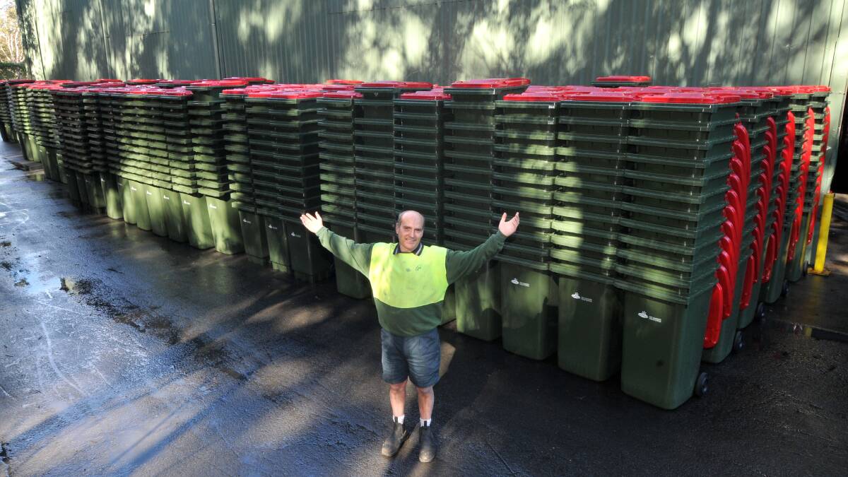 Ready to go: JR Richards leading hand Brett Savage with some of the red bins ahead of their delivery.