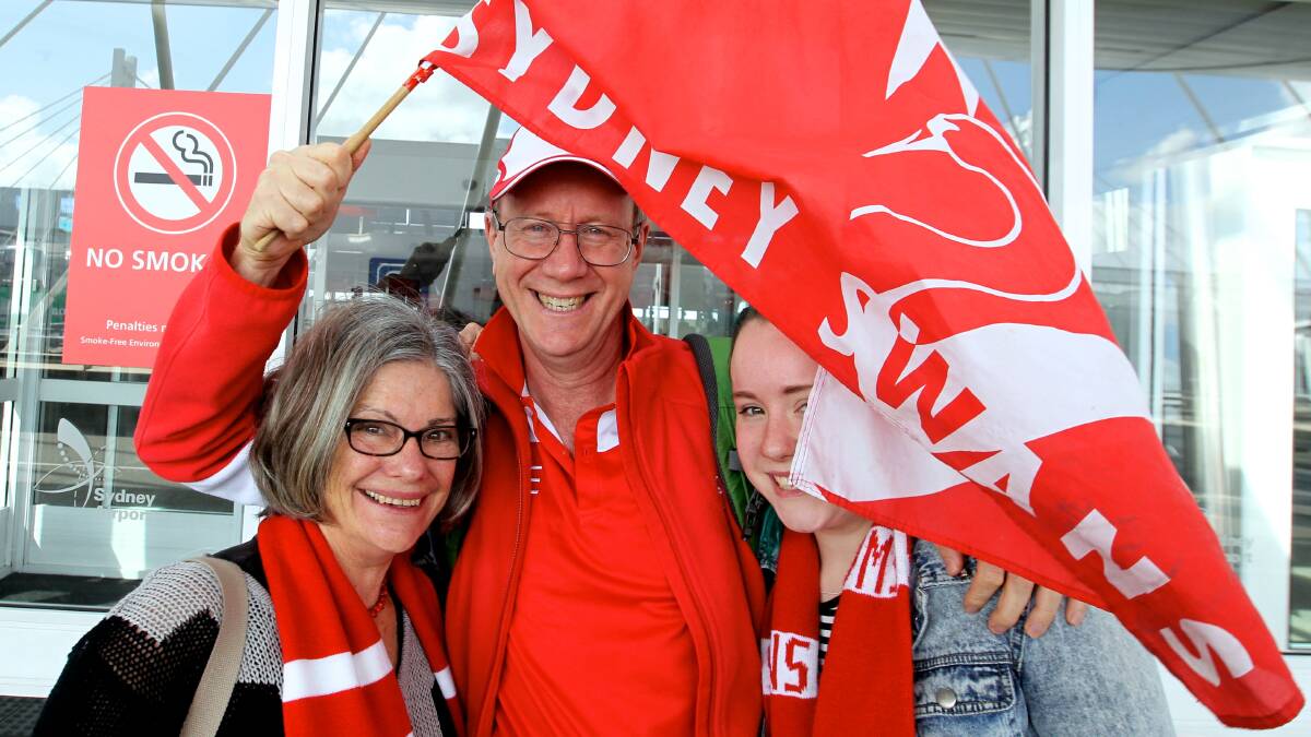 Swans fans leave Sydney headed for the AFL Grand Final in Melbourne:  Lyne Dunbar, Peter and Tess Watterson from Denistone. Photo: Ben Rushton, Fairfax Media. 