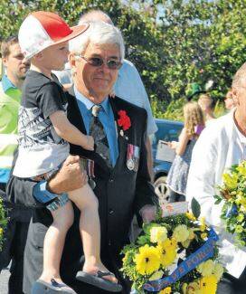 Greg Cavanagh, ex national serviceman, with his grandson Brax, who raced out to join him in the mid-morning parade.
