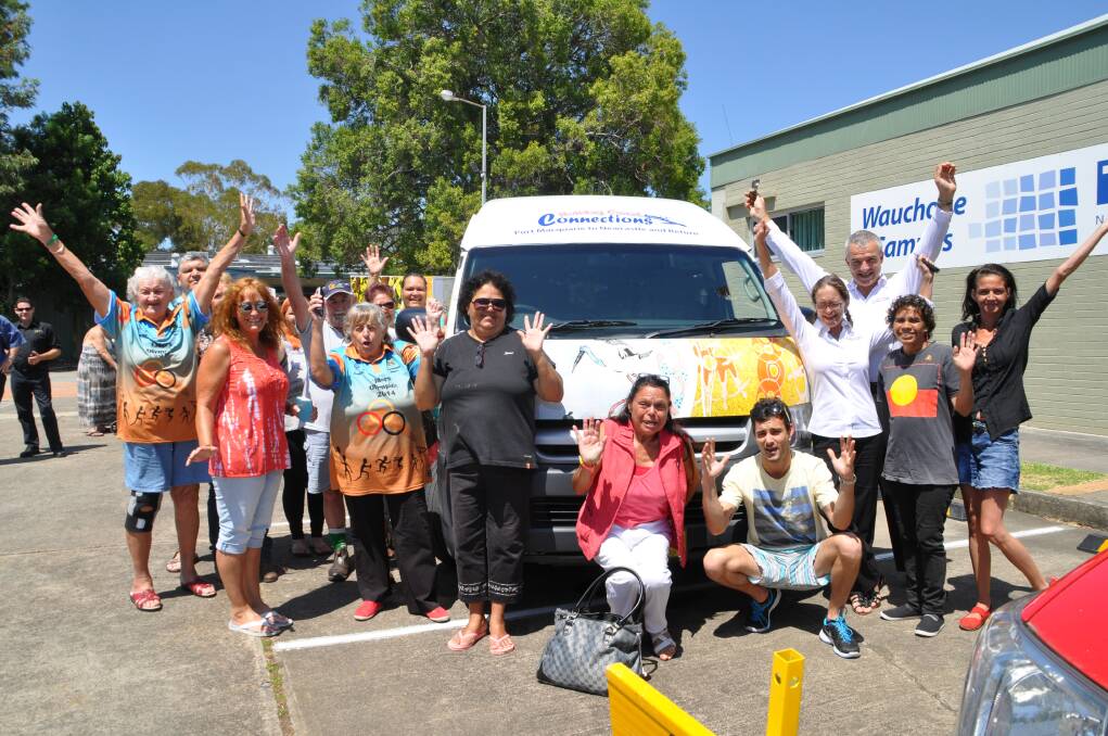 Local effort: Wauchope TAFE Aboriginal and Torres Strait Islander Cultural Arts students and Holiday Coast Connections bus operators with the bus and trailer bearing the students' artwork - originally created as silk batiks representing "spirit of place".