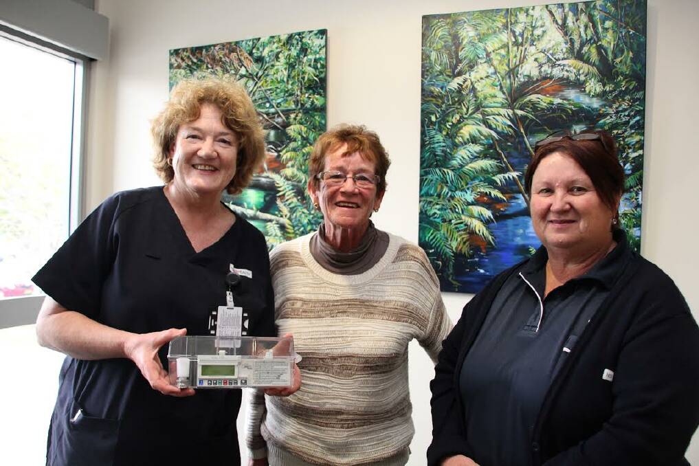 Golfers on course: The Palliative Care Unit's Acting Nursing Unit Manager Kerrie McFarland and Wauchope Ladies Golf Club president Jeanette Hardy with the medication dispenser purchased with the club's $1800 donation. The funds were raised at the club's recent Pamper Day, which was supported by Bloomin' Beautiful Events owner Debbie Jones (right)