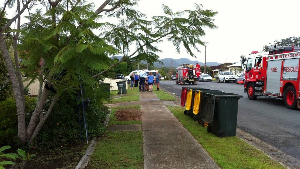 Lucky escape: Police at the scene of the accident near Thomas' Butchery taking statements at Wauchope on Monday.