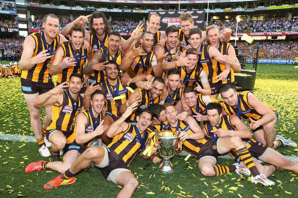 Sydney started well until the Hawks launched a physical tornado that blew the Swans away by 63 points at yesterday's AFL Grand Final at the MCG. The Hawks celebrate their win. Photo: Getty Images
