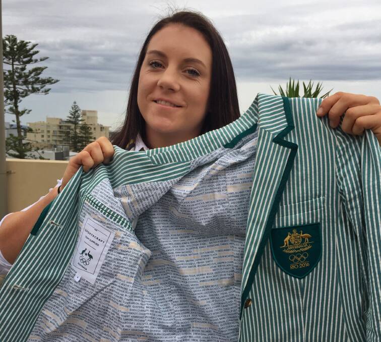 HONOURING CHAMPIONS PAST: Shelley Watts said it means so much to be able to wear her Olympic uniform. The lining features the names of Australian Olympic medalists from all previous Olympics.