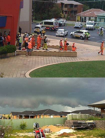 Emergency workers at the cinema in Bathurst after freeing nearly 40 people following a sudden storm.