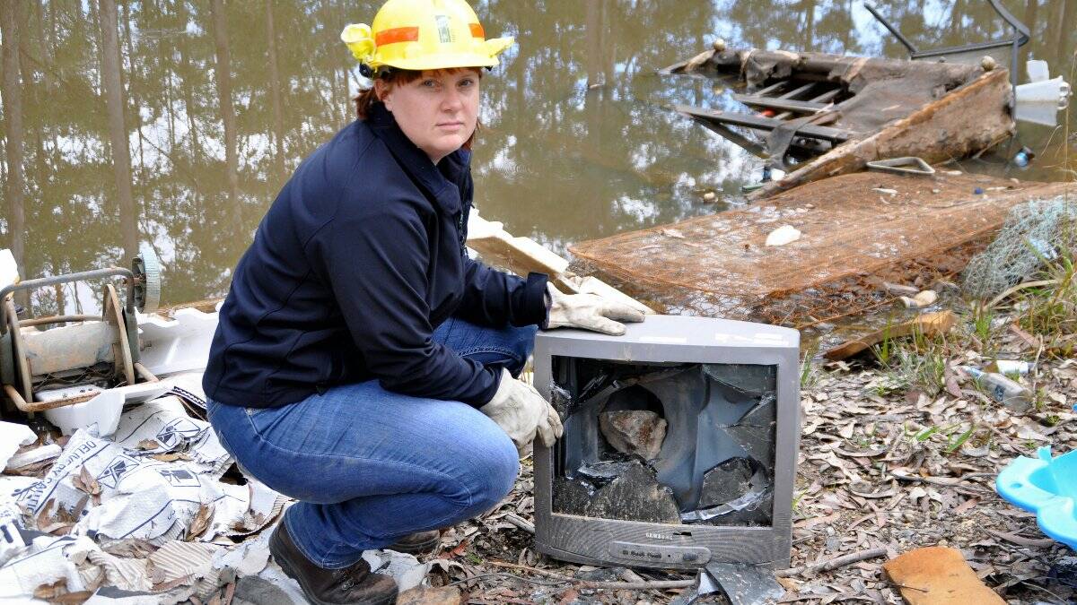 Forests NSW Central Region operations team leader Tamara Campbell with some of the rubbish left in the forest.
