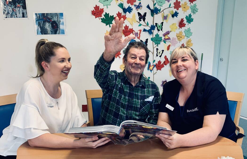 Leisure and Lifestyle Co-ordinator, Tarryn McSpadden and Director of Care, Michelle McKenna reminisce about buses with Johnstone Street resident Mr Peter Sonter.