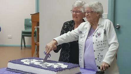 Sixty years: Wauchope Senior Citizens members Brenda Foster and Von Hall cutting the 60th birthday cake.