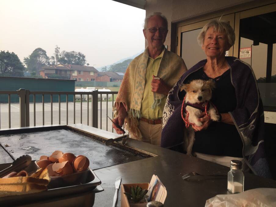 What a community: John Davies and Janice Allen - and the dog - were part of the community spirit on show at the Laurieton United Services Club.