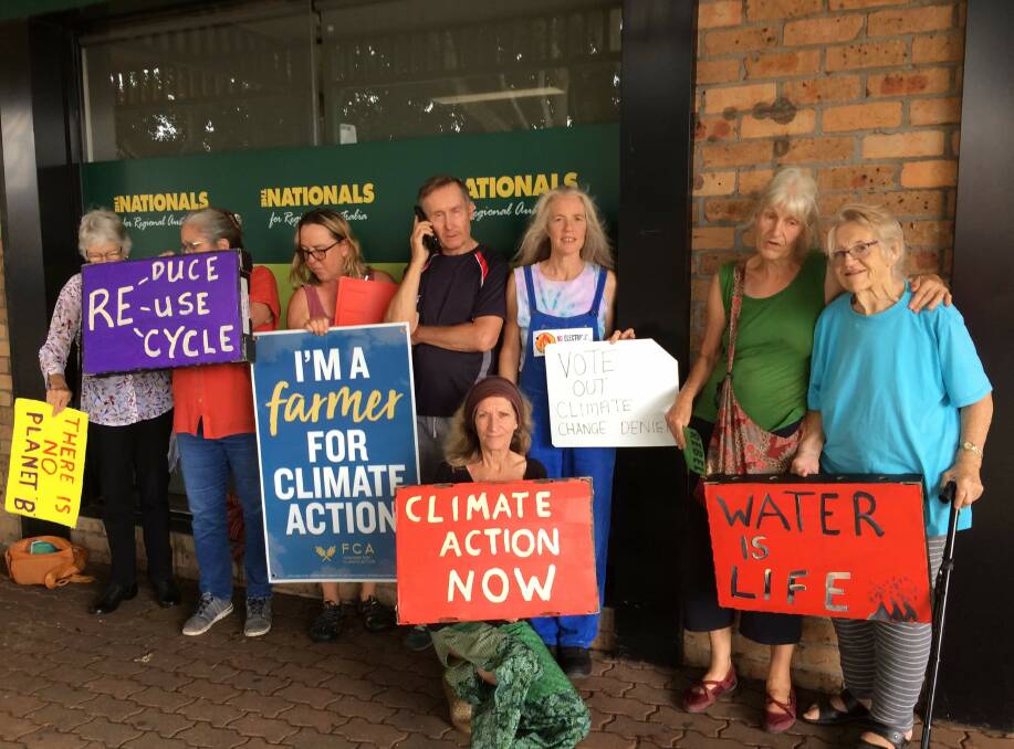 Friday protest: A group of protesters meeting outside Dr David Gillespie's electorate office in Wauchope. The group meets each Friday to protest about inaction on climate change.
