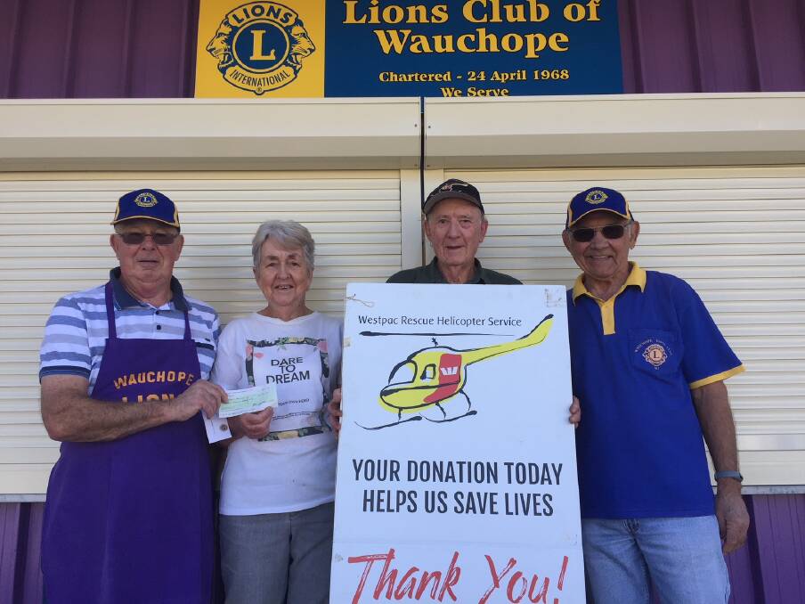Here you go: Lions' Jim Munro, left, and Wally Dylko, with support group member Betty Ezzy and chairman Bruce Cant. Photo: supplied