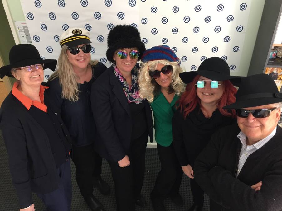 Stress less: Lifeline Mid Coast staff members Lee-Ann Foord, Kelly Saidey, Patti Taylor, Maria, Lisa Willows and Kurt Russell getting into the swing of things for July 24's Stress Down Day. Photo: Peter Daniels