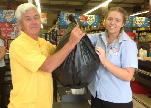 Congratulations: Wauchope Lions Club member Greg Cavanagh and IGA supervisor Huntah O’Brien drawing the winning ticket on October 6.