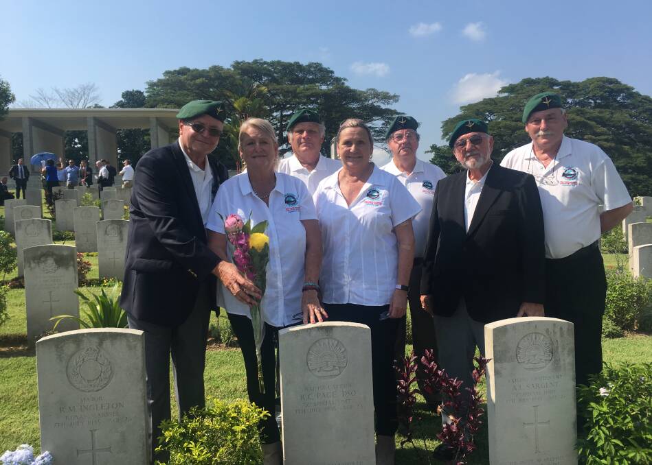 Remember them: Wauchoppe's Reg Pierce, third from left, standing behind the gravestone for Bob Page who was part of the Operation Jaywick and Rimau. Marking the anniversary are Mervyn Liddell, Kaye Bull, Susan Murdoch, Al Miles Kevin Hulton-Smith and Martin Blandy.