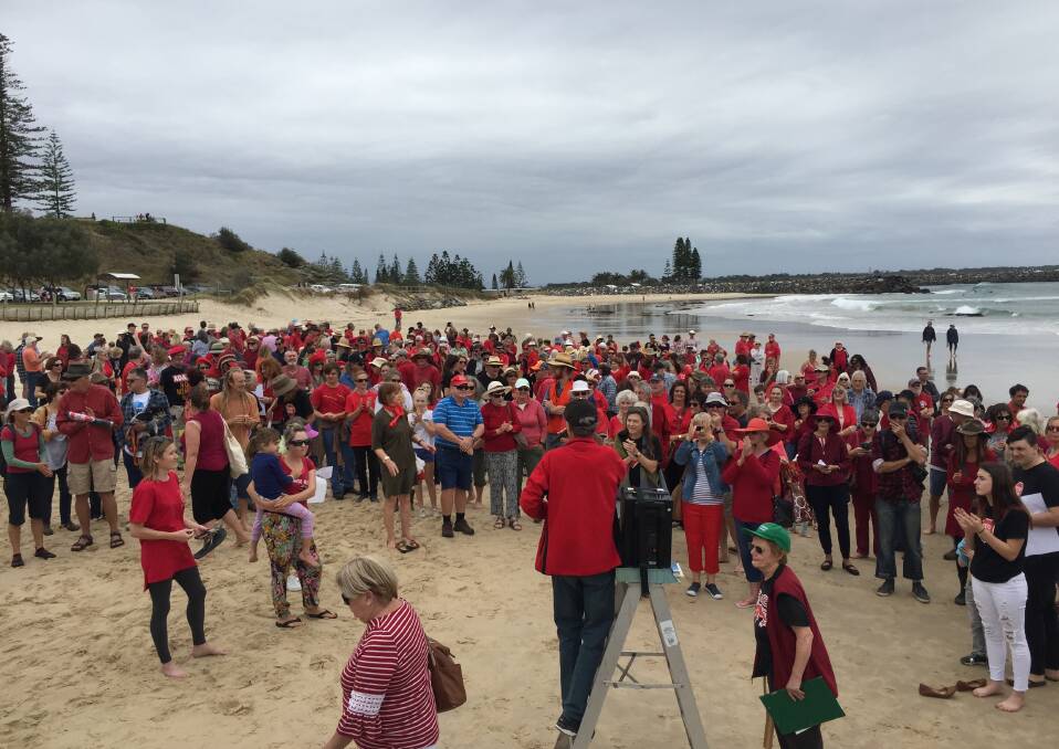 A sea of red: Hundreds of people attending Saturday's Stop Adani protest on Town Beach. The event was coordinated by Climate Change Australia Hastings branch.